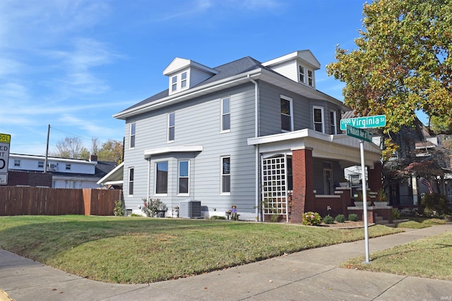 view of front facade featuring central air condition unit and a front lawn