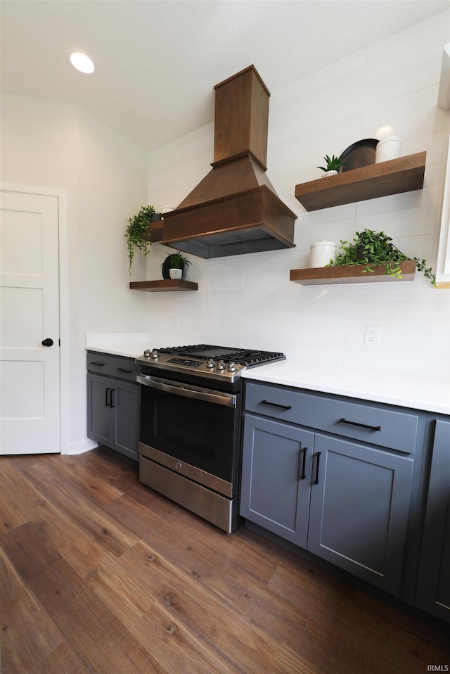 kitchen featuring premium range hood, gray cabinetry, gas stove, and dark hardwood / wood-style flooring