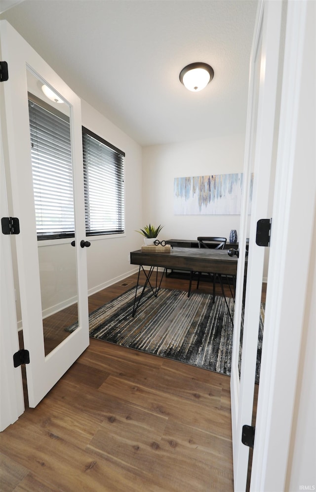 office featuring french doors and hardwood / wood-style flooring