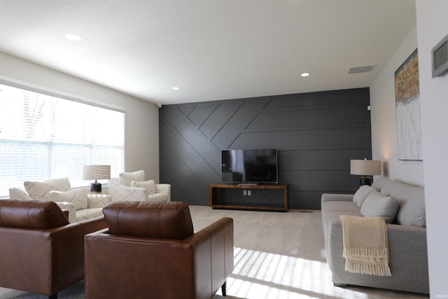 living room featuring light carpet and wood walls