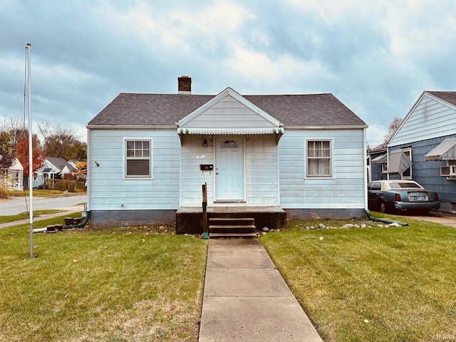 bungalow-style home with a front yard