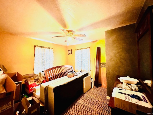 carpeted bedroom featuring a textured ceiling and ceiling fan