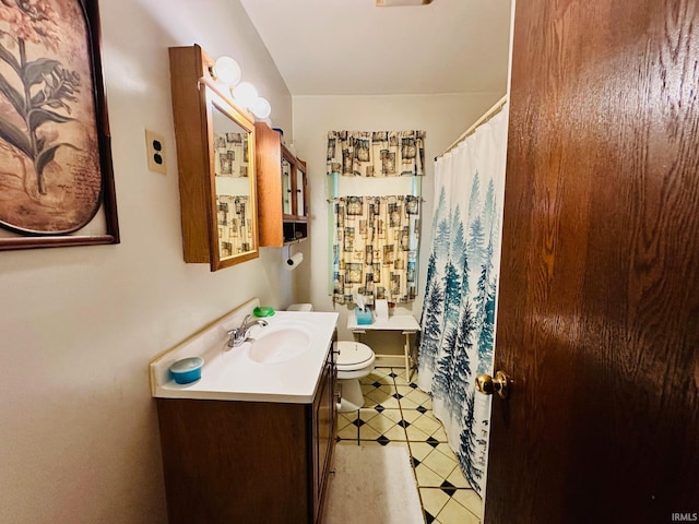 bathroom with vanity, toilet, and tile patterned floors