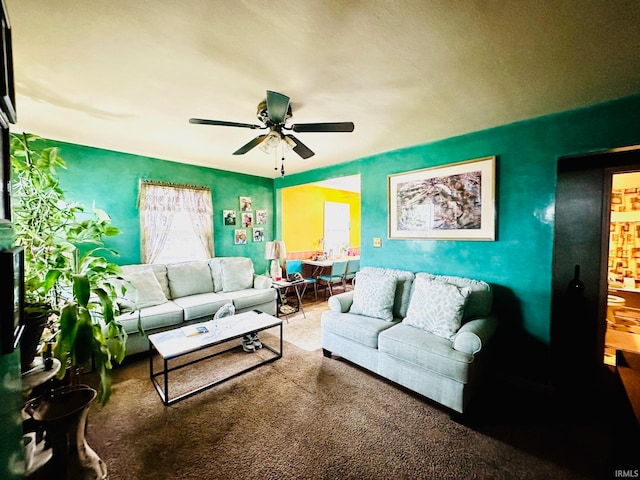 carpeted living room with ceiling fan