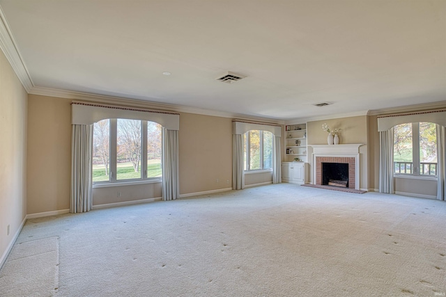 unfurnished living room with light carpet, a brick fireplace, built in features, and crown molding