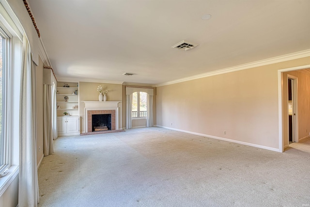 unfurnished living room with built in shelves, a fireplace, light colored carpet, and ornamental molding