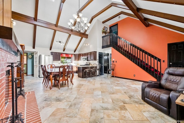 living room with beam ceiling, high vaulted ceiling, a brick fireplace, and a chandelier