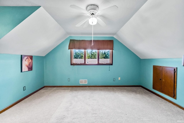 bonus room with ceiling fan, lofted ceiling, and light colored carpet