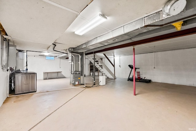 basement with washer / dryer and heating unit