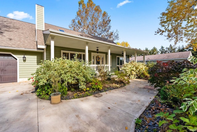 view of front of house featuring covered porch and a garage