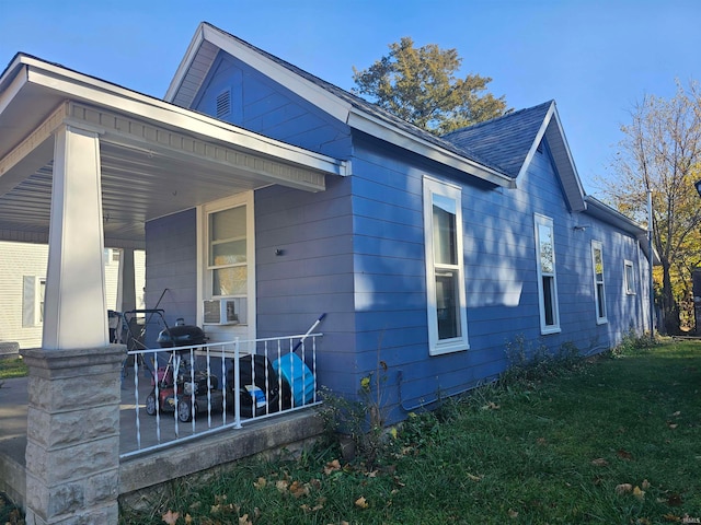 view of property exterior with a porch and cooling unit