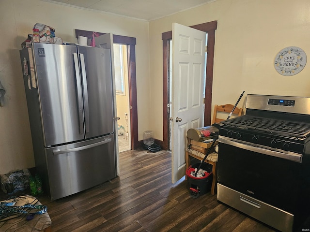 kitchen featuring appliances with stainless steel finishes, ornamental molding, and dark hardwood / wood-style flooring