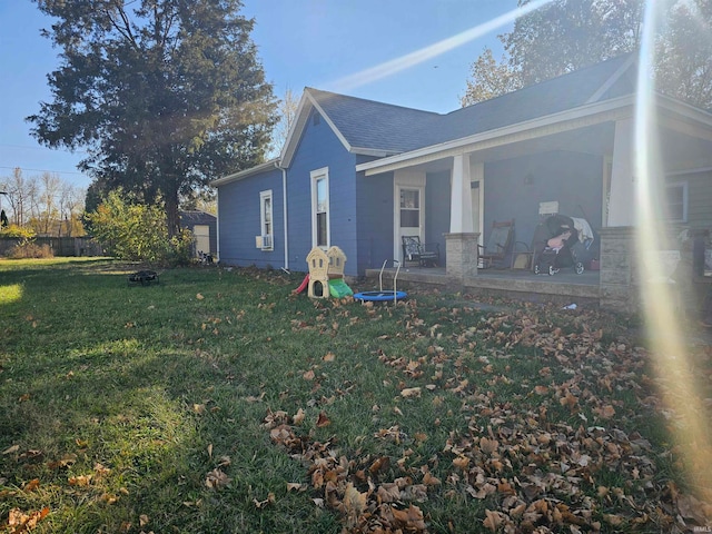 view of side of home with a yard and a patio