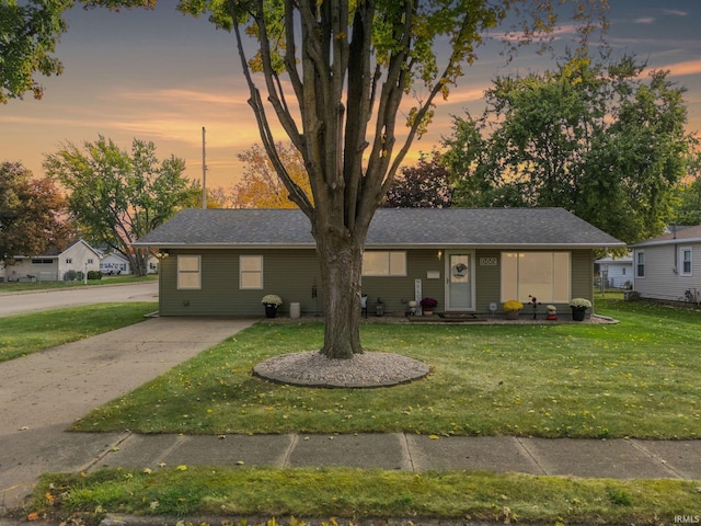 ranch-style home with a yard