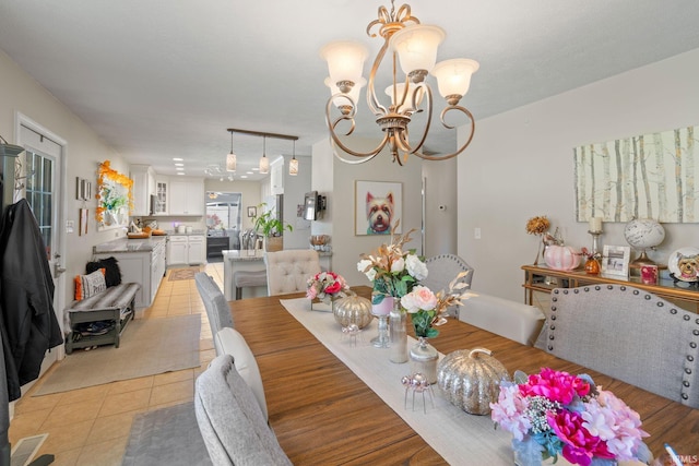 tiled dining space featuring an inviting chandelier