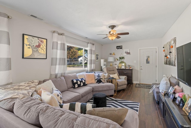 living room featuring ceiling fan and dark hardwood / wood-style flooring