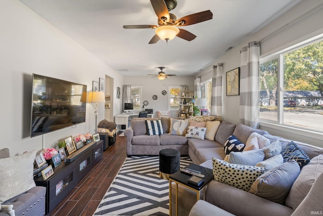 living room featuring dark wood-type flooring and ceiling fan