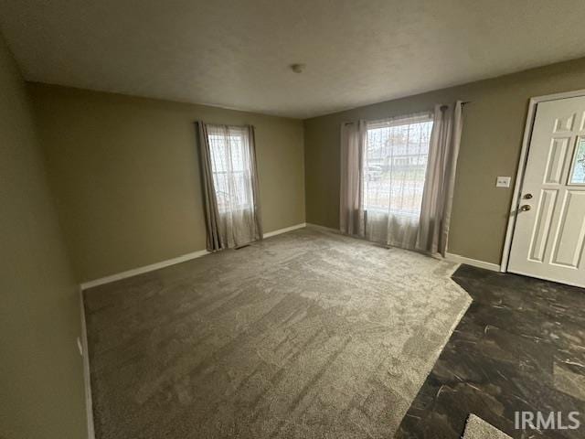 carpeted empty room with plenty of natural light