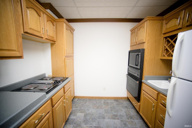 kitchen with sink, black appliances, and crown molding