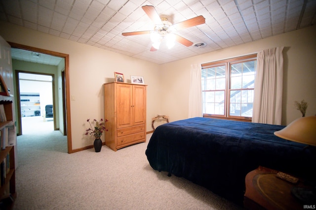 bedroom featuring light colored carpet and ceiling fan