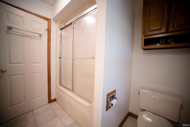 bathroom with toilet, enclosed tub / shower combo, and tile patterned flooring