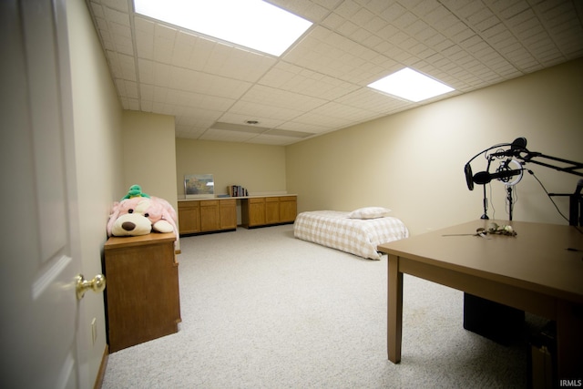 carpeted bedroom featuring a paneled ceiling