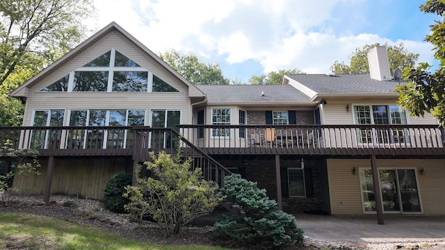 back of property featuring a deck and a patio