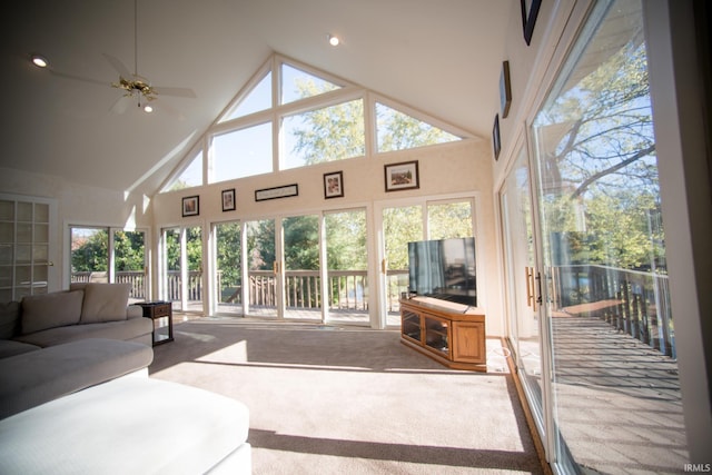 sunroom / solarium with ceiling fan and vaulted ceiling