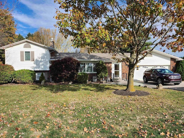 view of front of house with a front yard and a garage