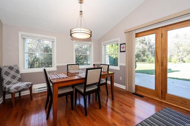 dining room featuring vaulted ceiling, baseboard heating, and dark hardwood / wood-style flooring