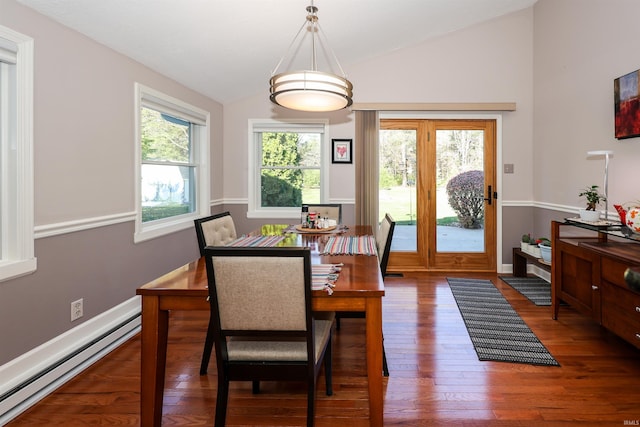 dining space featuring dark hardwood / wood-style flooring, a baseboard radiator, and vaulted ceiling