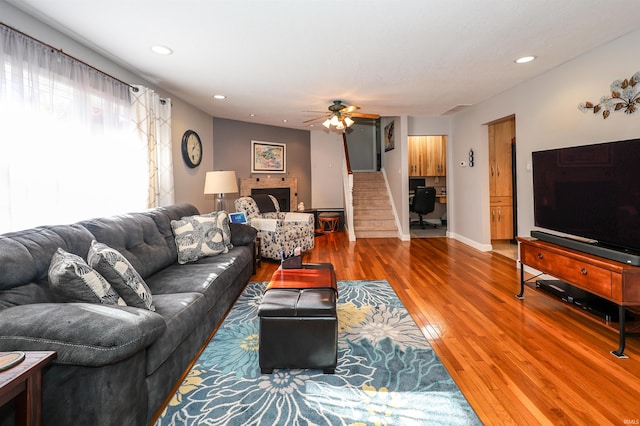 living room with hardwood / wood-style flooring and ceiling fan