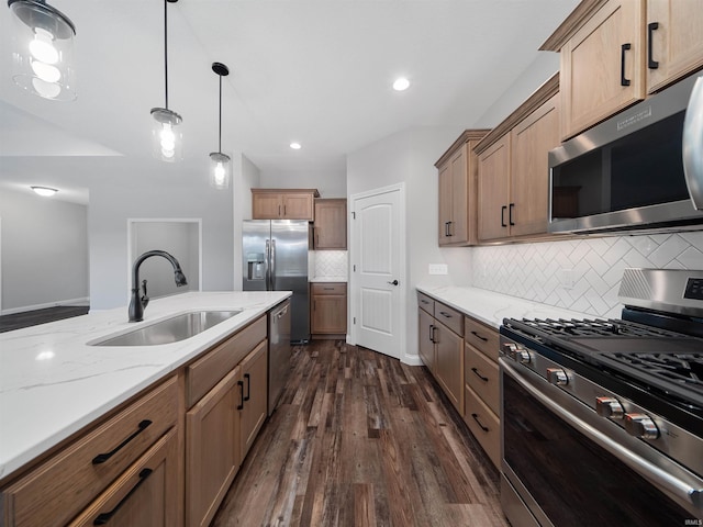 kitchen featuring decorative backsplash, sink, dark hardwood / wood-style floors, pendant lighting, and appliances with stainless steel finishes