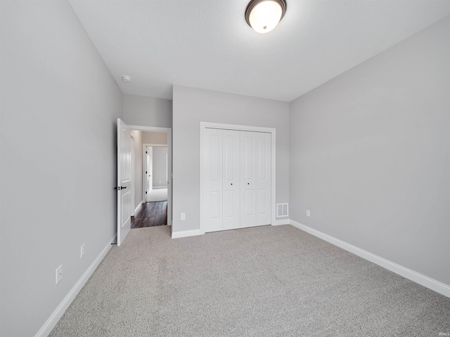 unfurnished bedroom with a closet and carpet