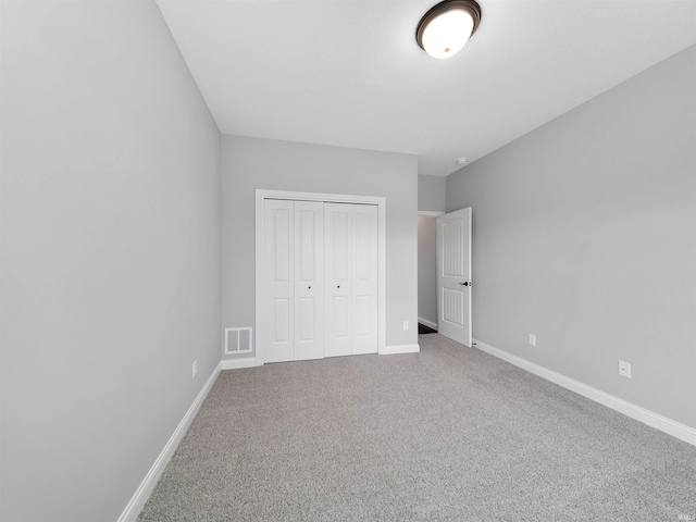 unfurnished bedroom featuring a closet and carpet floors