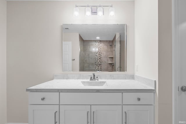 bathroom featuring vanity and a tile shower