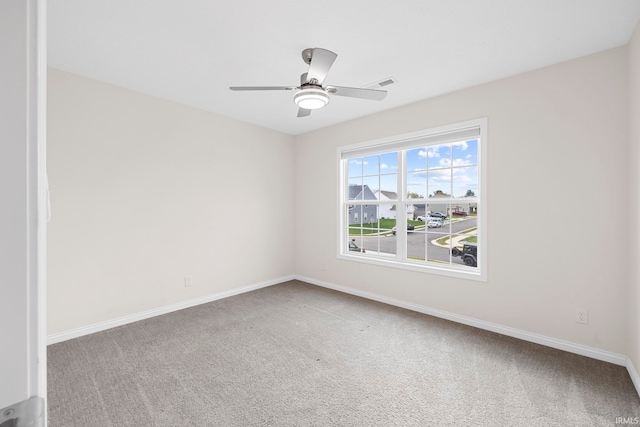 empty room with ceiling fan and carpet flooring