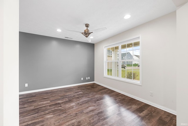 empty room with dark hardwood / wood-style flooring and ceiling fan