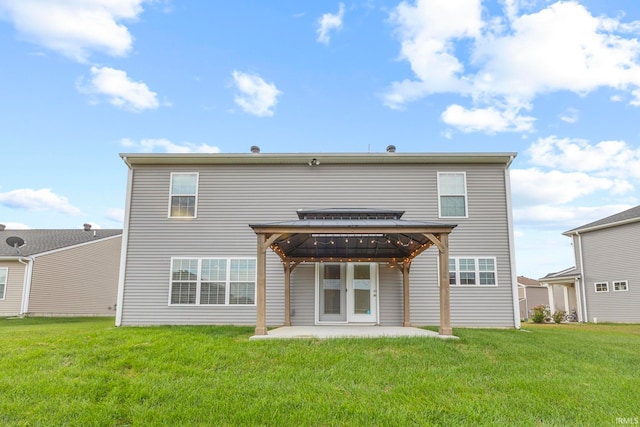 rear view of house featuring a yard and a patio area