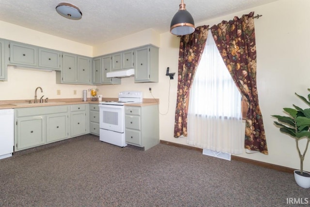 kitchen with dark colored carpet, white electric stove, a textured ceiling, and sink