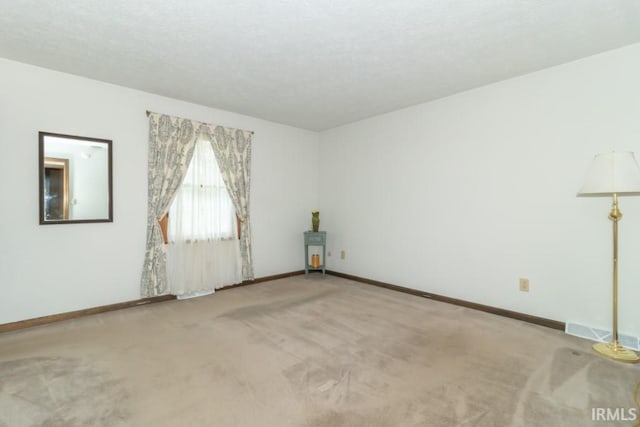 empty room with light colored carpet