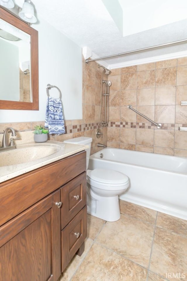 full bathroom with toilet, vanity, tiled shower / bath, and tile patterned floors