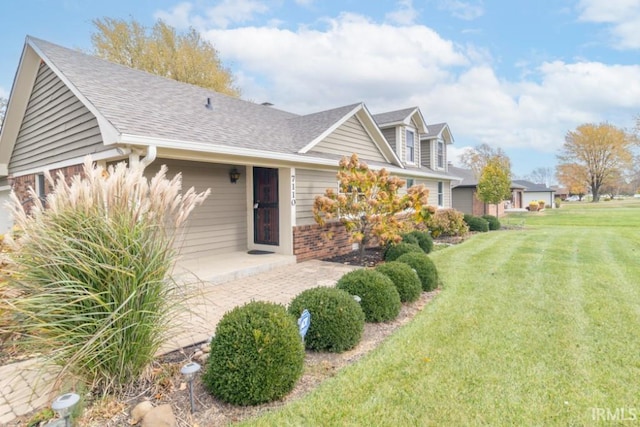 view of front facade with a front lawn and a patio area