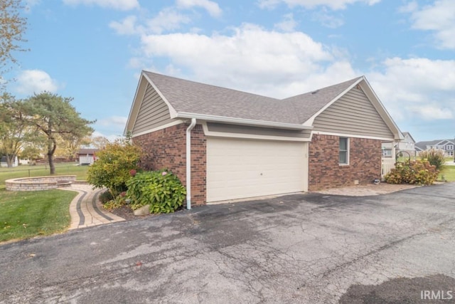 view of home's exterior with a lawn and a garage