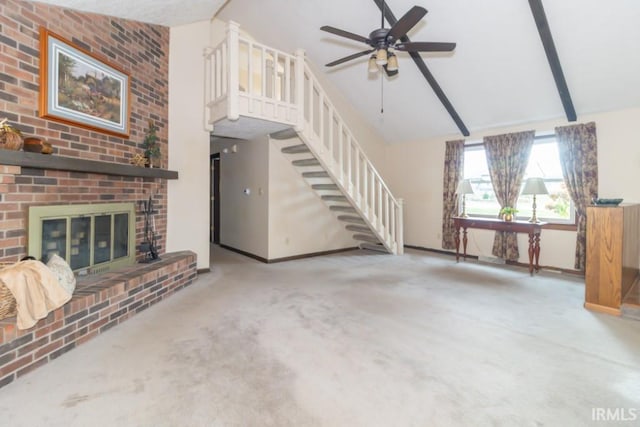 unfurnished living room with light carpet, ceiling fan, beam ceiling, high vaulted ceiling, and a fireplace