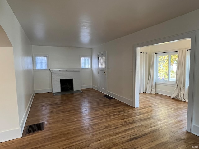 unfurnished living room featuring dark hardwood / wood-style floors and a fireplace