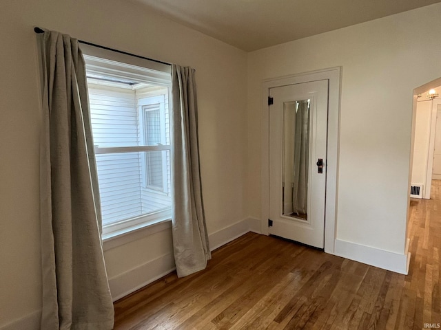 empty room featuring hardwood / wood-style flooring