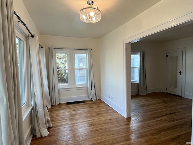 spare room featuring dark wood-type flooring