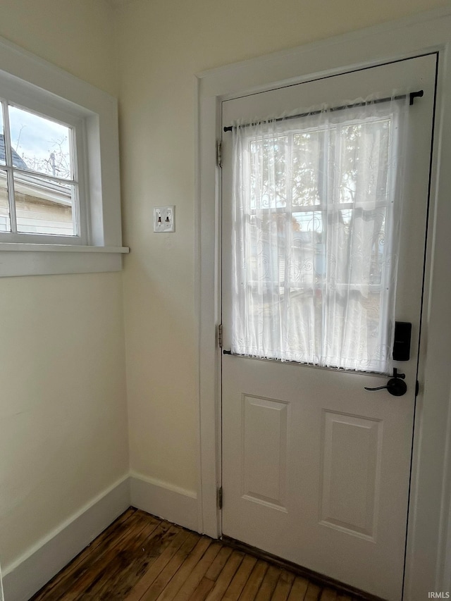 doorway with dark hardwood / wood-style floors