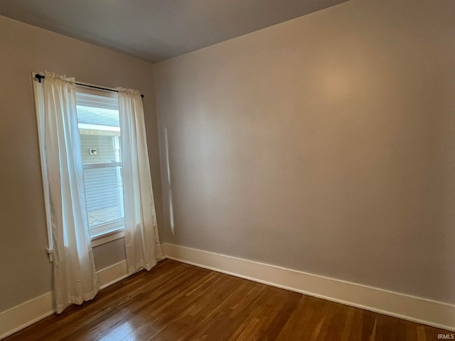 spare room with dark hardwood / wood-style flooring